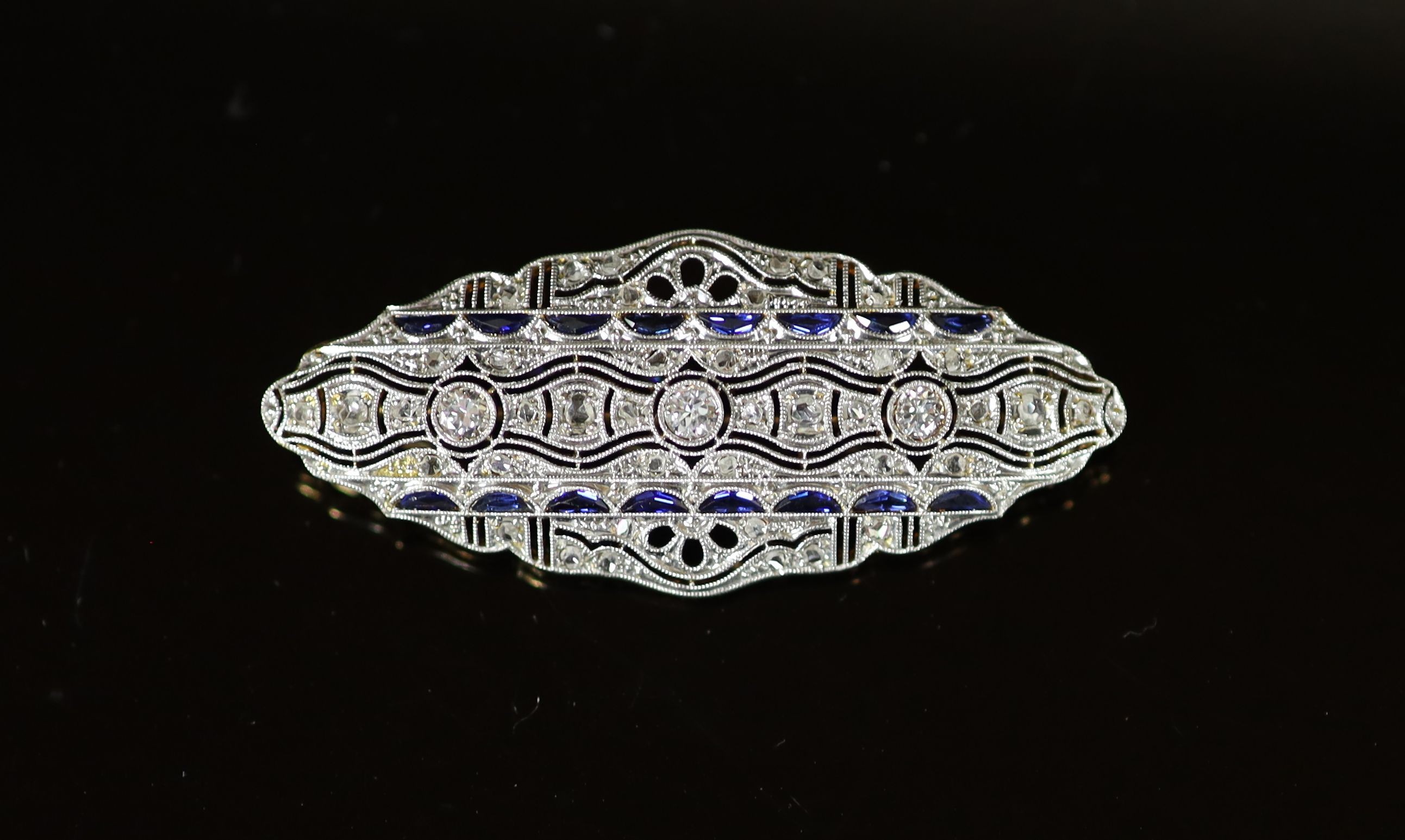 A Belle Epoque gold and platinum, diamond and shaped cut sapphire millegrain set brooch
